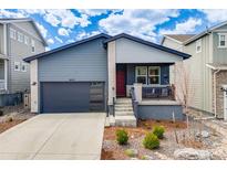 Charming single-Gathering home features a red door, two-car garage, and well-manicured landscaping at 8517 Eckley St, Littleton, CO 80125