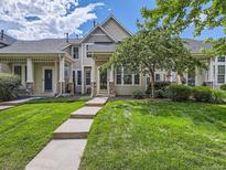Inviting townhouse with a well-maintained lawn and charming architectural details at 5155 W Quincy Ave # J103, Denver, CO 80236