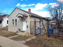 Charming exterior showcasing a quaint home with a small covered entryway and partially fenced yard at 914 La Farge Ave, Louisville, CO 80027