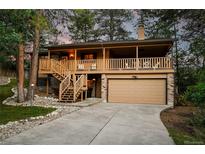 Inviting two-story home featuring a charming covered porch and a convenient two-car garage at 9416 Mcshane Ct, Parker, CO 80134