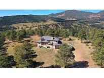 A captivating home with an incredible mountain view and mature trees on sprawling acreage at 6300 Summer Star Ln, Golden, CO 80403