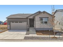 Charming single-Gathering home featuring stone accents, a two-car garage, and a well-maintained front yard at 22036 E 39Th Pl, Aurora, CO 80019