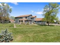 Charming townhome with a well-manicured lawn and inviting exterior in a desirable community at 8408 Everett Way # B, Arvada, CO 80005