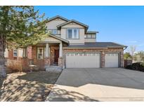 Charming two-story home with brick accents, three-car garage, and manicured lawn at 24676 E Florida Ave, Aurora, CO 80018