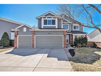 Charming two-story home featuring a three-car garage and brick accents at 6982 Mountain Brush Cir, Highlands Ranch, CO 80130