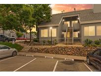 Charming condo complex with reserved parking, stone landscaping, and a welcoming entrance with stairs at 8500 E Jefferson Ave # 16B, Denver, CO 80237