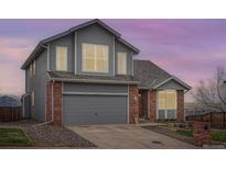 Charming two-story home featuring a brick and gray wood exterior with a two-car garage at 16645 W 2Nd Ave, Golden, CO 80401