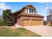 Charming brick home with a two-car garage and well-maintained lawn at 9239 Erminedale Dr, Lone Tree, CO 80124