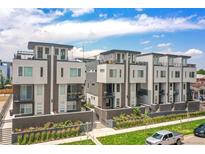 Modern townhomes with balconies, roof decks, brick accents, and manicured landscaping offer luxury living at 1583 Grove St # 5, Denver, CO 80204