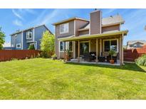 Expansive backyard with lush green lawn, covered patio area perfect for outdoor entertaining at 13235 Clermont Cir, Thornton, CO 80241