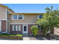 Charming townhome featuring a brick facade and well-maintained landscaping in a desirable neighborhood at 1545 S Ouray Cir # B, Aurora, CO 80017