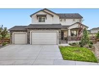 Attractive two-story home featuring a three-car garage and stone accents, showcasing its curb appeal at 16881 Roaming Elk Dr, Monument, CO 80132