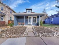 Charming single Gathering home featuring a cozy front porch with seating, nice landscaping and appealing exterior paint at 3922 Winona Ct, Denver, CO 80212
