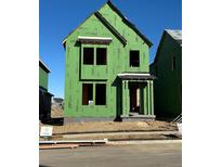 Two-story house with green exterior and landscaping at 223 Washington St, Erie, CO 80516