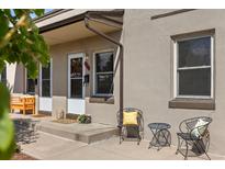Charming front porch with seating area and decorative welcome mat, inviting curb appeal for this home at 2616 Utica St, Denver, CO 80212