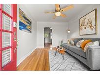 Inviting living room with hardwood floors, a gray couch, and an artistic decor at 2616 Utica St, Denver, CO 80212