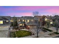 Stunning home featuring an eye-catching lawn, mature trees, and a welcoming entrance at 12850 Ventana St, Parker, CO 80134