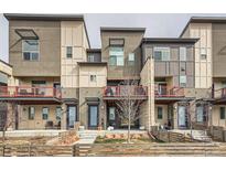 Modern townhome exterior showcasing a stylish facade, private balconies, and well-maintained landscaping at 5676 Emporia St, Denver, CO 80238