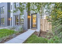 Modern two-story home with gray brick exterior and landscaped front yard at 2945 S Elati St, Englewood, CO 80110