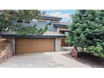 Charming two-story home featuring a two-car garage, stone accents, and mature trees in a desirable location at 6503 Big Horn Trl, Littleton, CO 80125