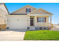 House exterior featuring a two-car garage and front porch at 2268 Base St, Fort Lupton, CO 80621