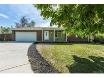 Charming single-story home featuring a well-maintained lawn, driveway, and attached garage at 2120 S Ouray St, Aurora, CO 80013