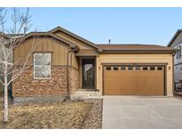Charming single-Gathering home featuring stone accents, a two-car garage, and a well-maintained front yard at 5056 S Wenatchee St, Aurora, CO 80015