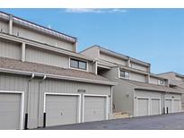 View of the exterior of the townhomes with attached garages and visible unit numbers at 10530 W Jewell Ave # 303, Lakewood, CO 80232