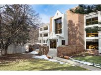 Inviting condo exterior with a well-maintained lawn, brick accents, and visible unit number at 315 Arapahoe Ave # 202, Boulder, CO 80302