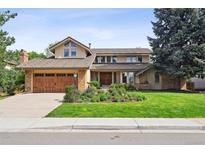 Charming two-story home featuring a well-maintained lawn and a spacious two-car garage at 5149 E Links Cir, Centennial, CO 80122