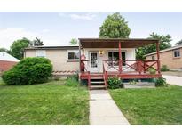 Charming home with covered porch, well-kept lawn, and walkway leading to the front door at 7839 Florado St, Denver, CO 80221
