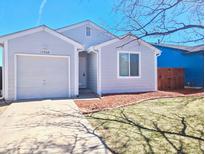 Charming single-story home featuring a front yard, attached garage, and neutral exterior at 17968 E Colgate Pl, Aurora, CO 80013