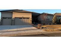 Charming single Gathering home featuring a three-car garage and beautifully landscaped front yard at 4265 Crystal Dr, Broomfield, CO 80023