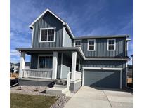 Charming two-story home featuring a welcoming front porch and attached two-car garage at 735 Sunflower Dr, Brighton, CO 80601