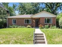 Charming brick home featuring a well-maintained lawn, lovely landscaping, and inviting front entrance at 2635 Julian St, Denver, CO 80211