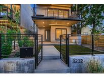 Contemporary home featuring a minimalist design, a gated entrance, and a second-story balcony at 3232 W 16 Ave, Denver, CO 80204