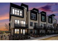 Modern townhome exterior with black framed windows, private balconies, and beautiful sunset sky at 2329 Lakeshore Ln # 14, Superior, CO 80027