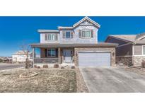 Charming two-story home with stone accents, covered porch, and well-maintained landscaping at 13903 Hillsboro Dr, Parker, CO 80134