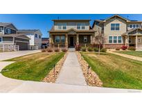 Charming two-story home with a landscaped front yard and inviting covered porch at 24043 E Florida Ave, Aurora, CO 80018