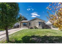 Charming ranch home with landscaped lawn and walkway at 1957 Hanover St, Aurora, CO 80010