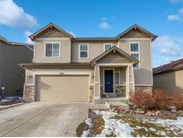 Two-story house with beige siding, a two-car garage, and a landscaped front yard at 6327 Agave Ave, Castle Rock, CO 80108