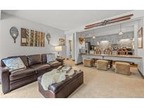 Inviting living room boasts comfortable seating, vintage decor, and a seamless flow into the adjacent kitchen at 1179 Ski Hill Rd # 147, Breckenridge, CO 80424
