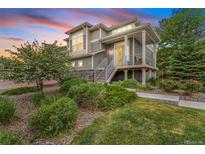 Charming two-story home with well-maintained landscaping, stone accents, and a welcoming front porch at 18056 E 104Th Way, Commerce City, CO 80022