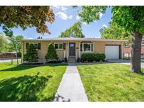 Charming ranch-style home with a well-manicured lawn and a welcoming front entrance at 12162 W Dakota Dr, Lakewood, CO 80228