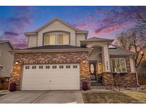 Charming two-story home featuring a brick facade, a two-car garage, and a well-maintained front yard under a beautiful sky at 3764 Balderas St, Brighton, CO 80601