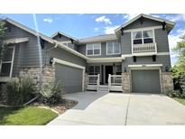 Charming two-story home featuring a two-car garage, inviting porch, and well-manicured landscaping at 687 Briar Haven Dr, Castle Pines, CO 80108
