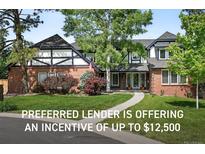 Charming two-story home with a brick facade, manicured lawn, and inviting walkway to the front door at 5441 S Dayton Ct, Greenwood Village, CO 80111