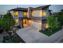 Beautiful two-story home featuring stone accents, a covered entrance, and a spacious three-car garage at 9441 Night Star Pl, Lone Tree, CO 80124