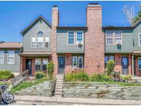 Attractive multi-level townhome with brick chimneys, garden beds, and a classic, traditional design at 17427 E Rice Cir # C, Aurora, CO 80015