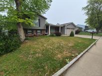 Charming two-story home with brick accents, blue shutters, and a well-maintained front yard at 1962 S Ivory Way, Aurora, CO 80013